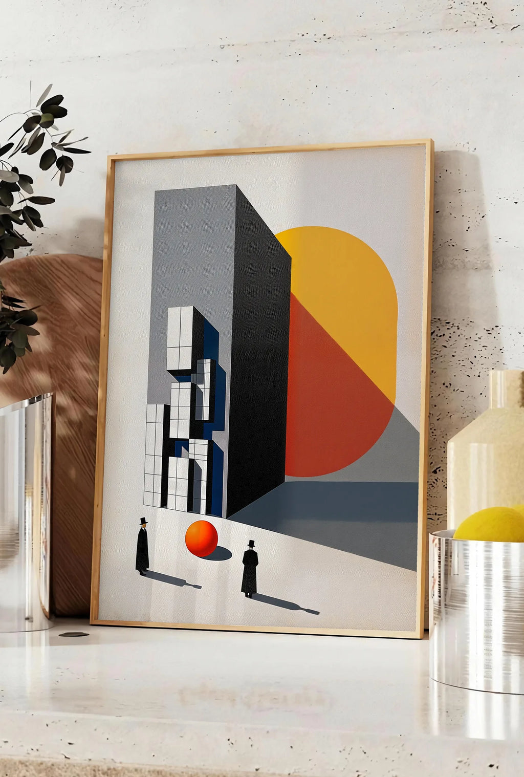 Affiche architecture et Spheres, posee sur un plan de travail de cuisine en pierre claire, entre une branche d'eucalyptus en vase et un bocal de citrons