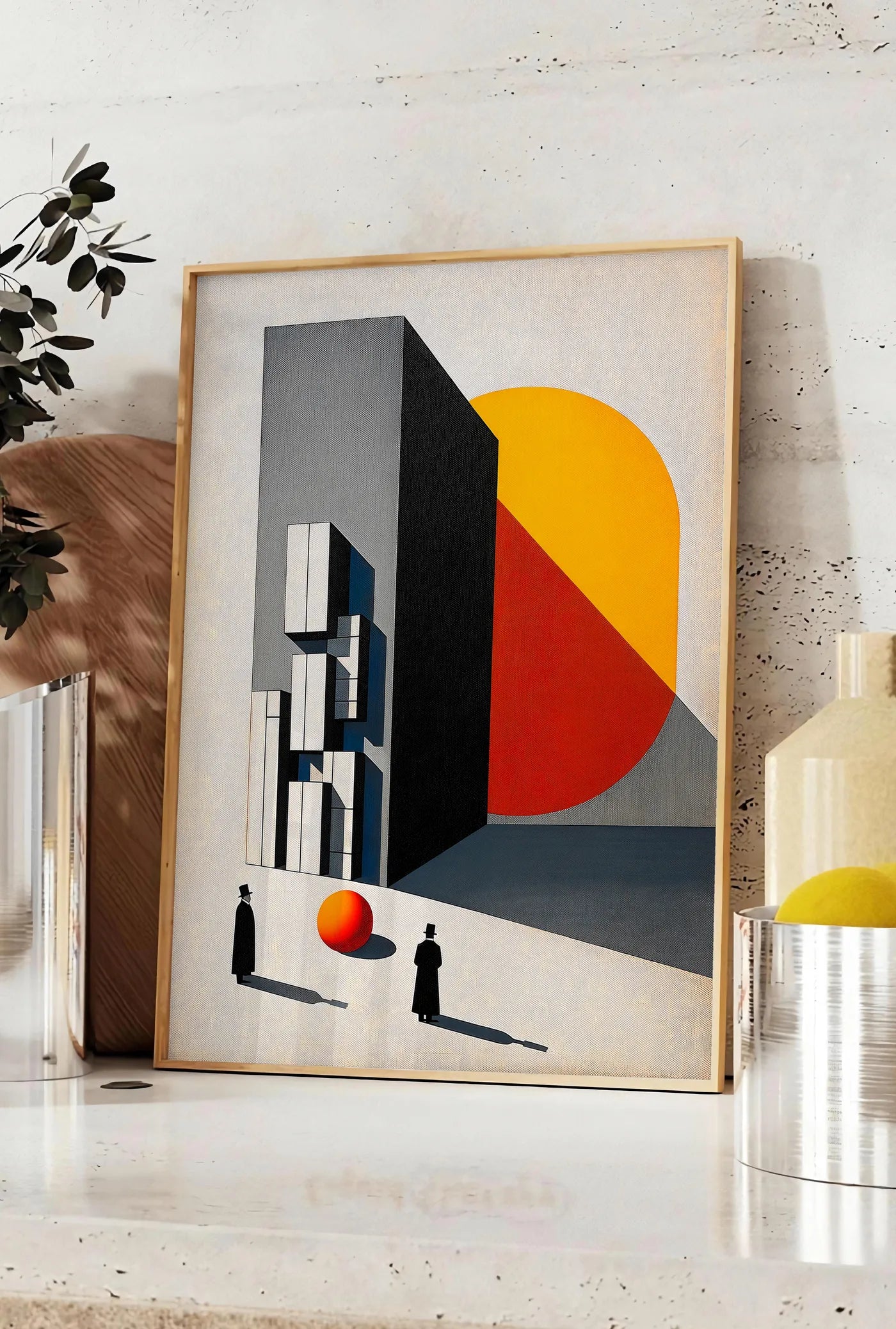 Affiche architecture Surreelle, posee sur un plan de travail de cuisine en pierre claire, entre une branche d'eucalyptus en vase et un bocal de citrons