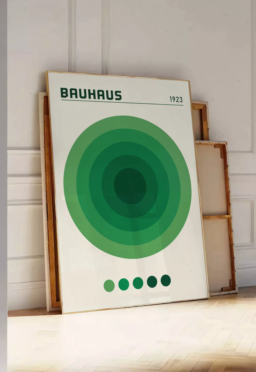 Tirage encadrable cercles Concentriques Verts, posee au sol dans une entree lumineuse, contre un mur a panneaux blancs, a cote de chassis en bois empiles