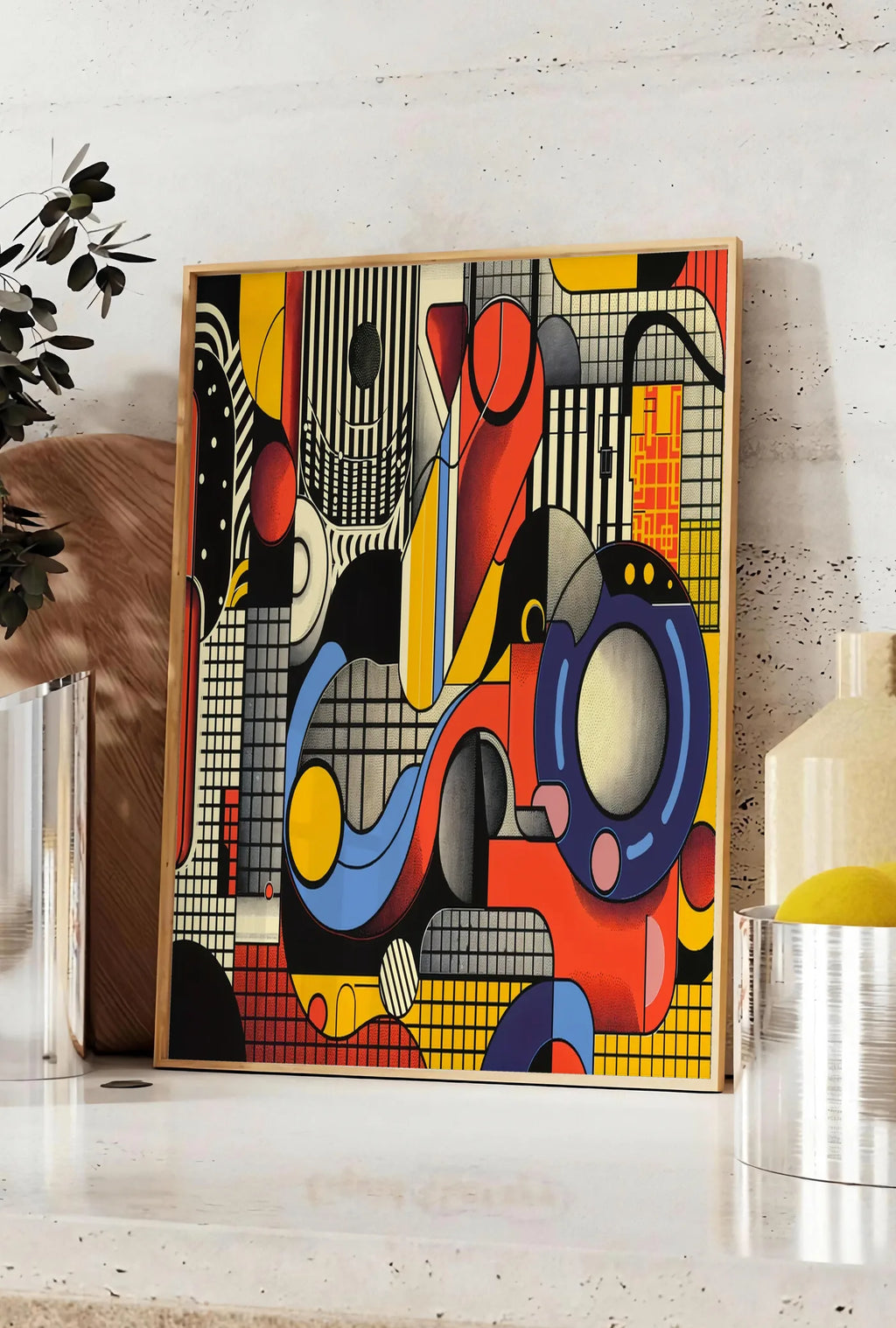 Affiche collage Machiniste, posee sur un plan de travail de cuisine en pierre claire, entre une branche d'eucalyptus en vase et un bocal de citrons