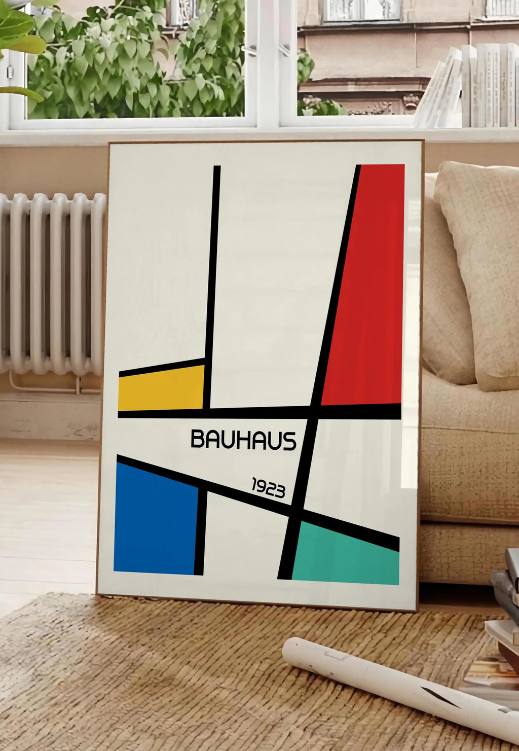 Poster mondrian Diagonal, posee au sol dans un salon parisien, devant une grande fenetre donnant sur un immeuble haussmannien, entre un ficus et un canape creme