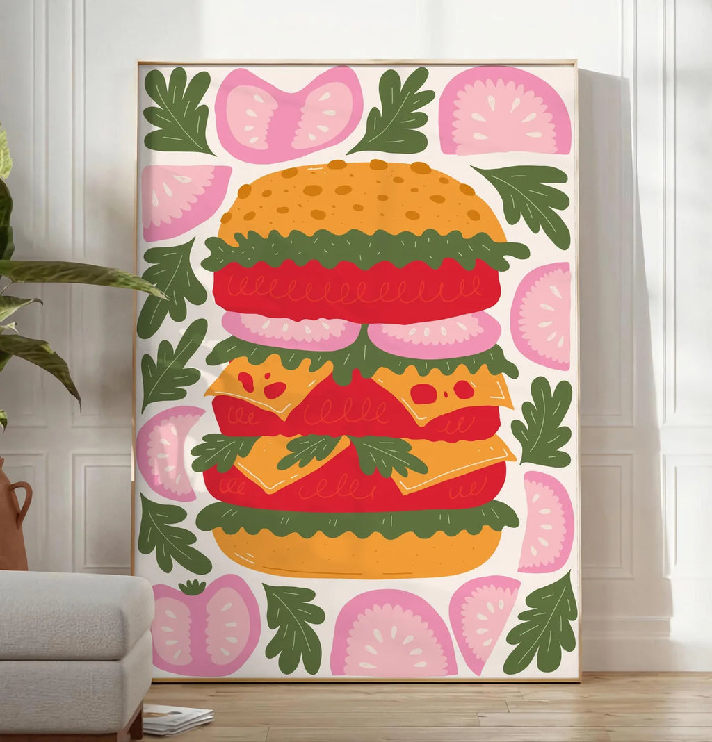 Reproduction affiche cuisine burger, posee au sol dans un salon minimaliste clair, a cote d'un canape beige et d'une plante verte, sur un parquet clair