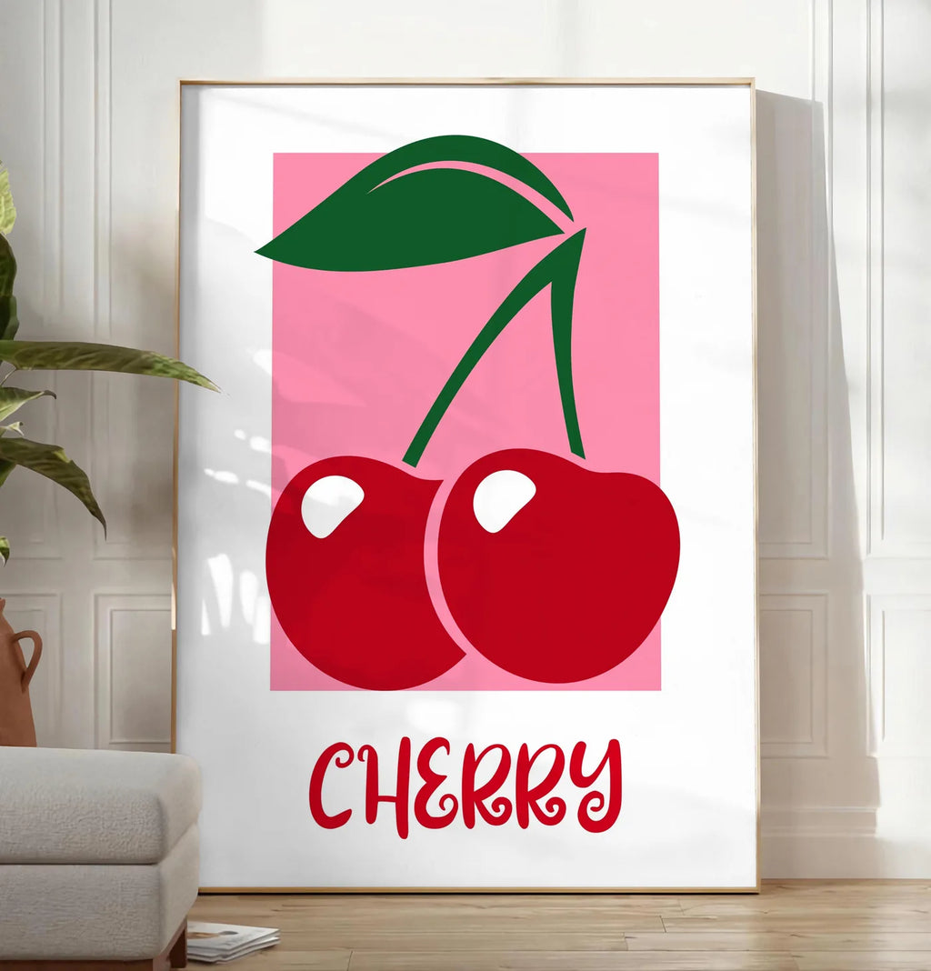 Reproduction affiche cuisine cerises cherry fruit rouges et feuille verte sur panneau rose, posee au sol dans un salon minimaliste clair, a cote d'un canape beige et d'une plante verte, sur un parquet clair