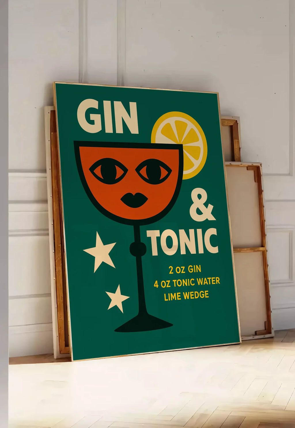 Tirage encadrable affiche gin tonic pop-art, posee au sol dans une entree lumineuse, contre un mur a panneaux blancs, a cote de chassis en bois empiles