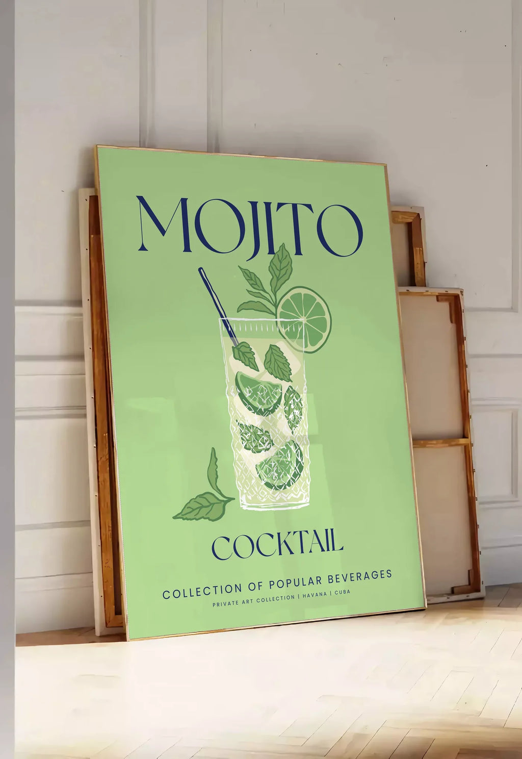 Tirage encadrable affiche mojito minimaliste, posee au sol dans une entree lumineuse, contre un mur a panneaux blancs, a cote de chassis en bois empiles