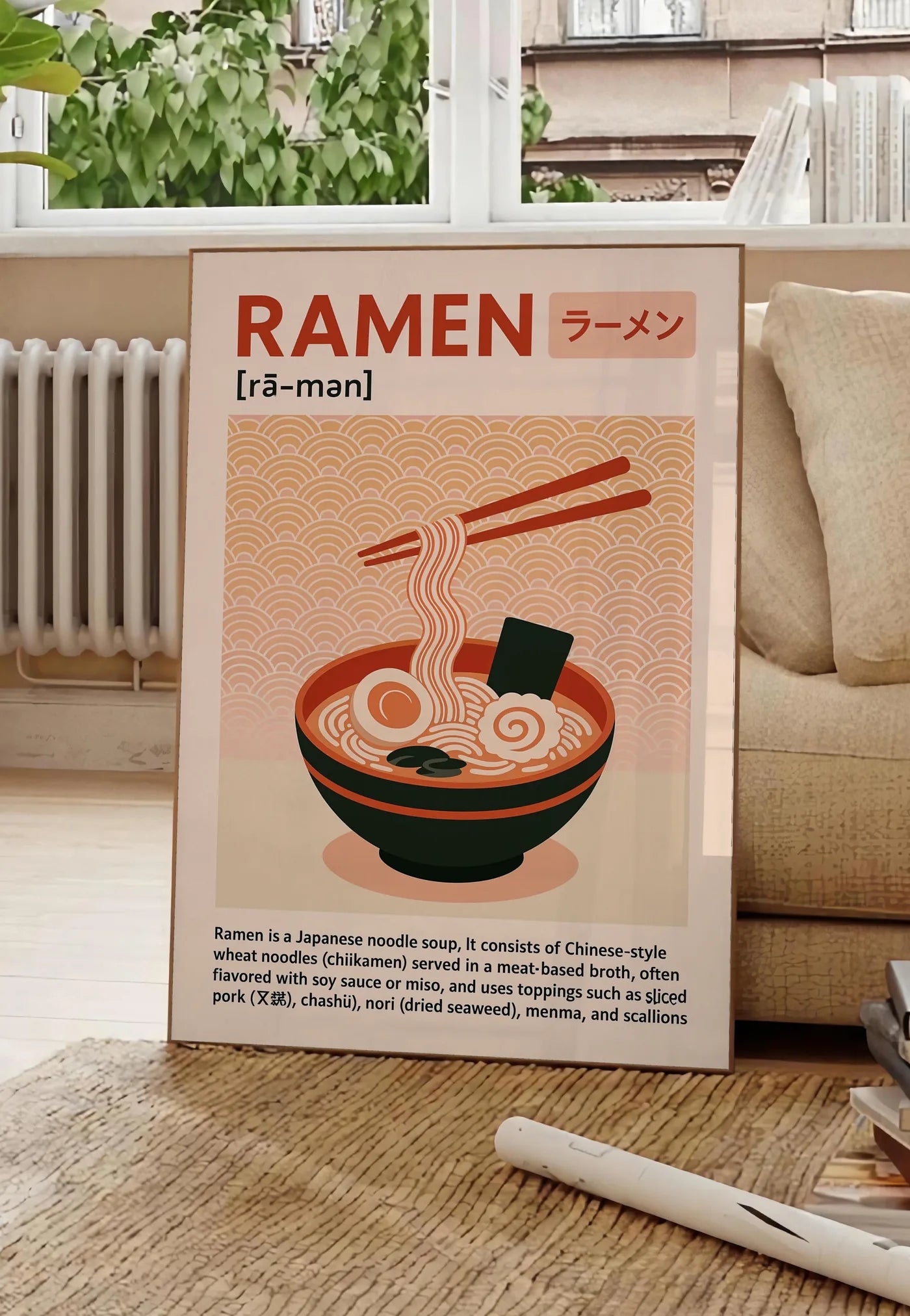 Poster affiche ramen cuisine, posee au sol dans un salon parisien, devant une grande fenetre donnant sur un immeuble haussmannien, entre un ficus et un canape creme