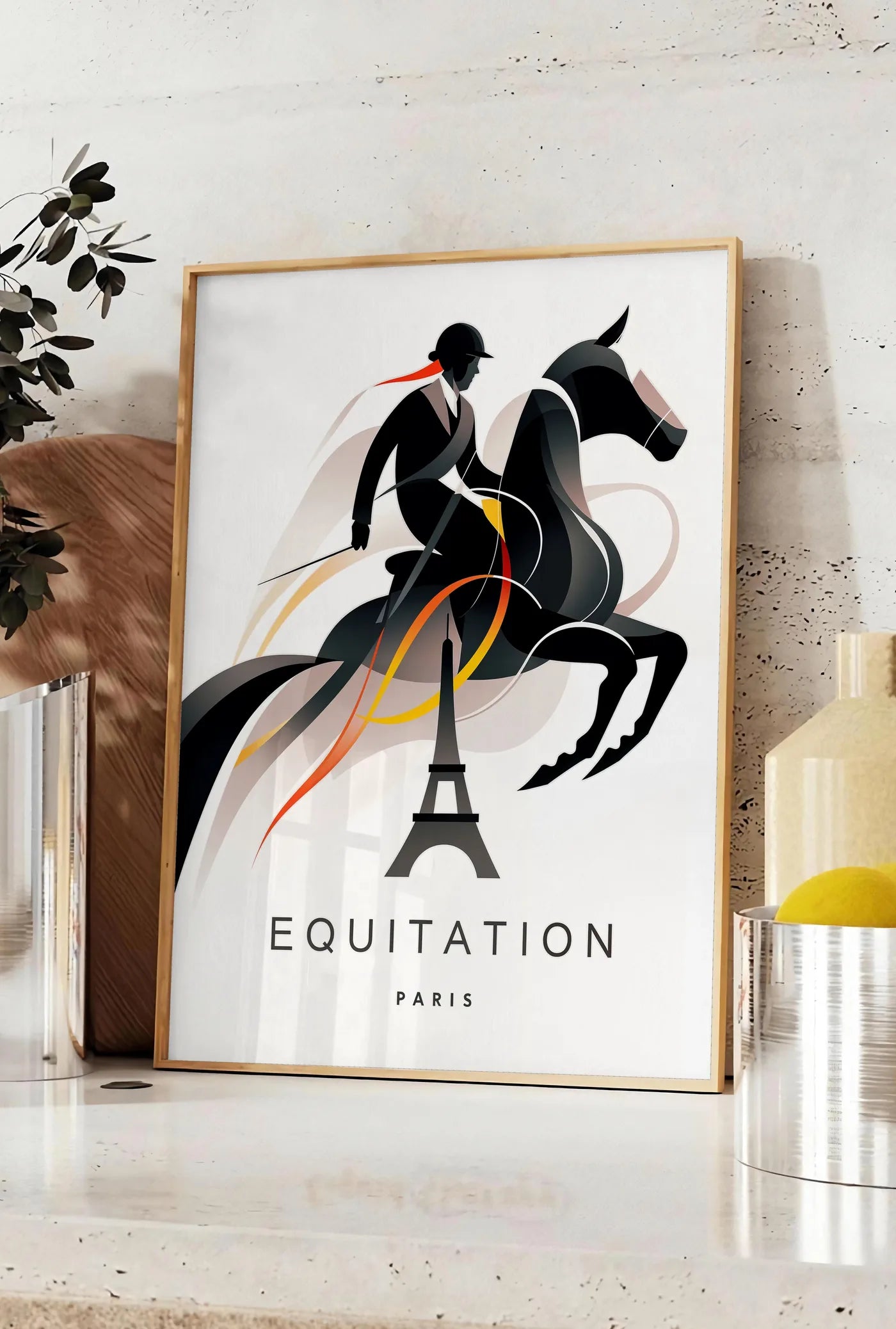 Affiche affiche equitation Paris, posee sur un plan de travail de cuisine en pierre claire, entre une branche d'eucalyptus en vase et un bocal de citrons