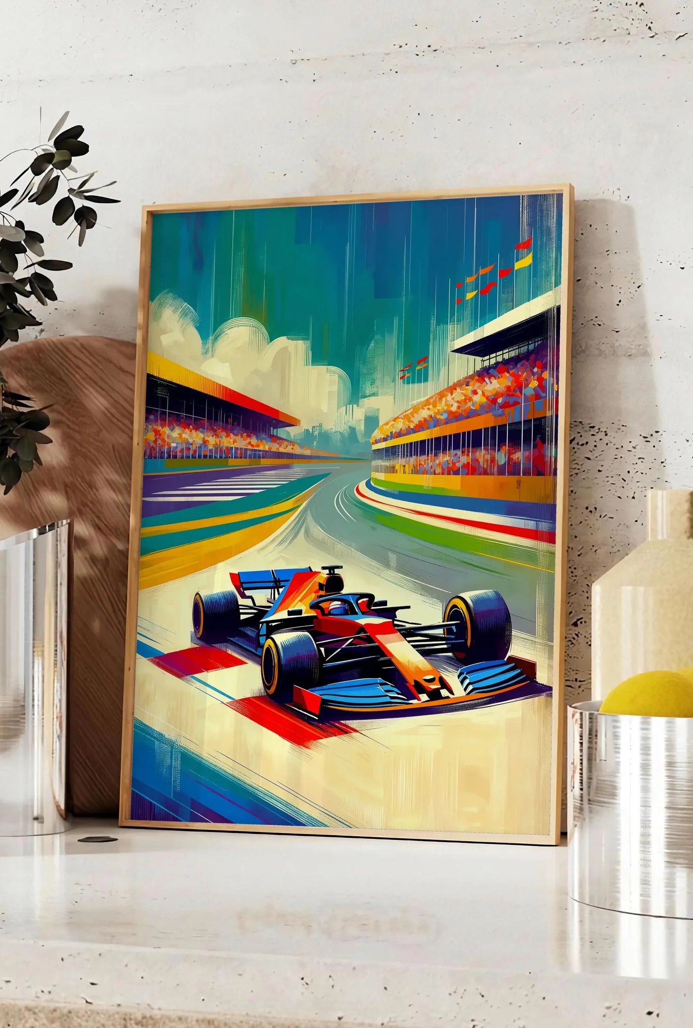 Affiche voiture de Formule 1 entrant dans un virage, posee sur un plan de travail de cuisine en pierre claire, entre une branche d'eucalyptus en vase et un bocal de citrons