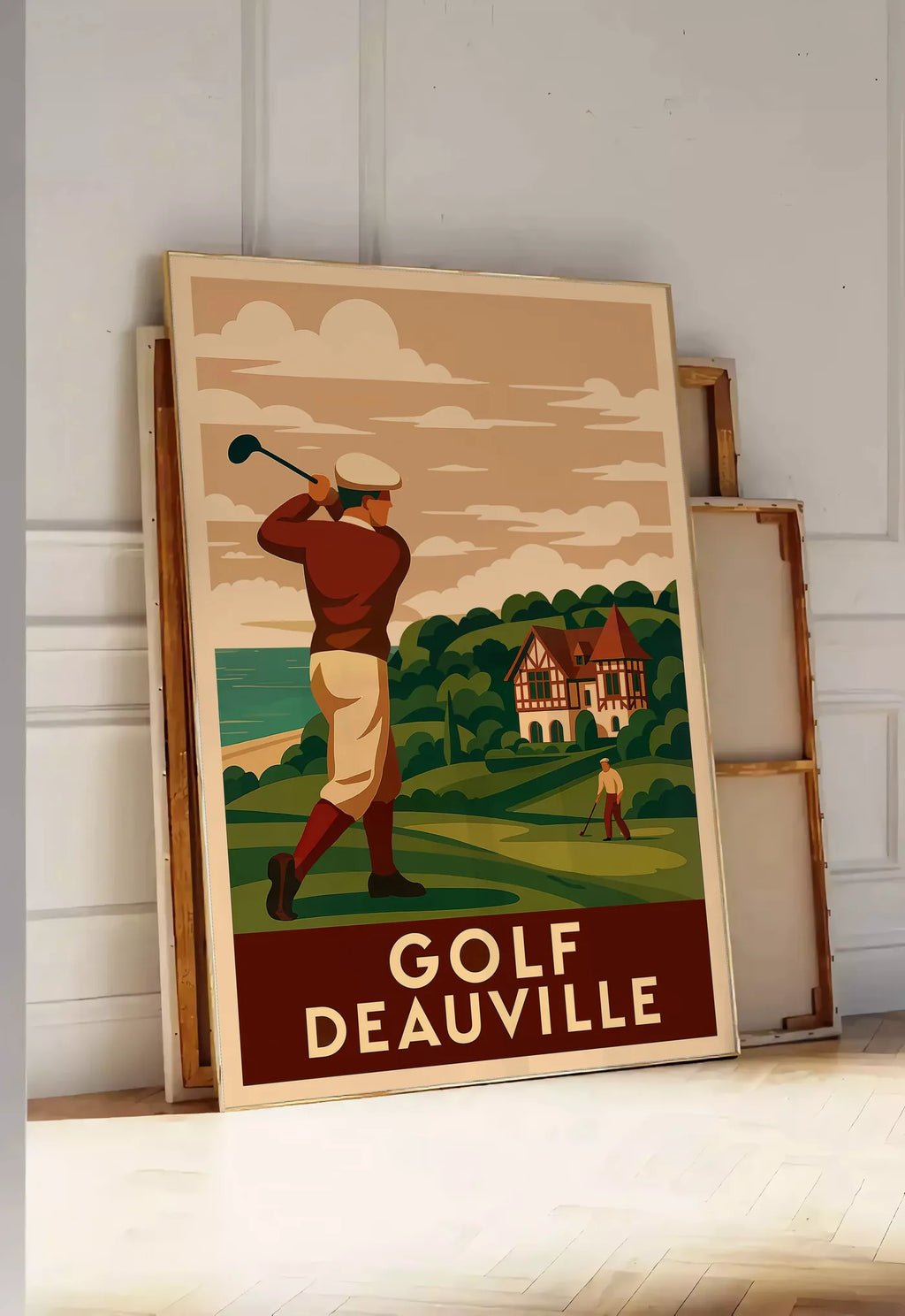 Tirage encadrable golfeur en swing face à la mer, posee au sol dans une entree lumineuse, contre un mur a panneaux blancs, a cote de chassis en bois empiles