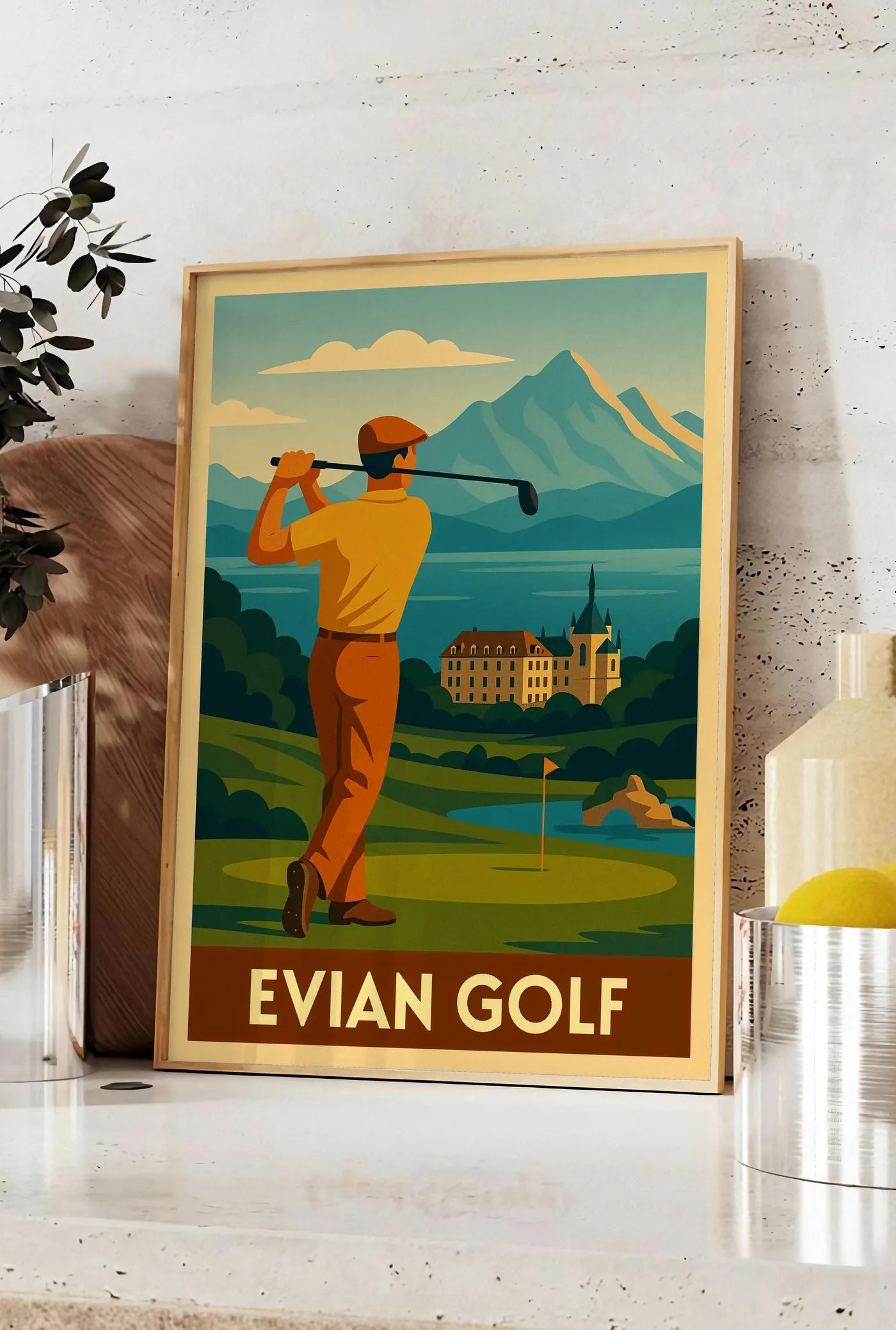 Affiche golfeur en backswing, posee sur un plan de travail de cuisine en pierre claire, entre une branche d'eucalyptus en vase et un bocal de citrons