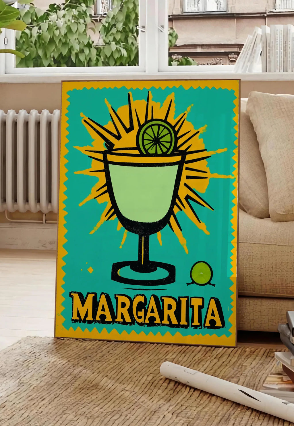 Poster affiche cocktail Margarita pop art, posee au sol dans un salon parisien, devant une grande fenetre donnant sur un immeuble haussmannien, entre un ficus et un canape creme