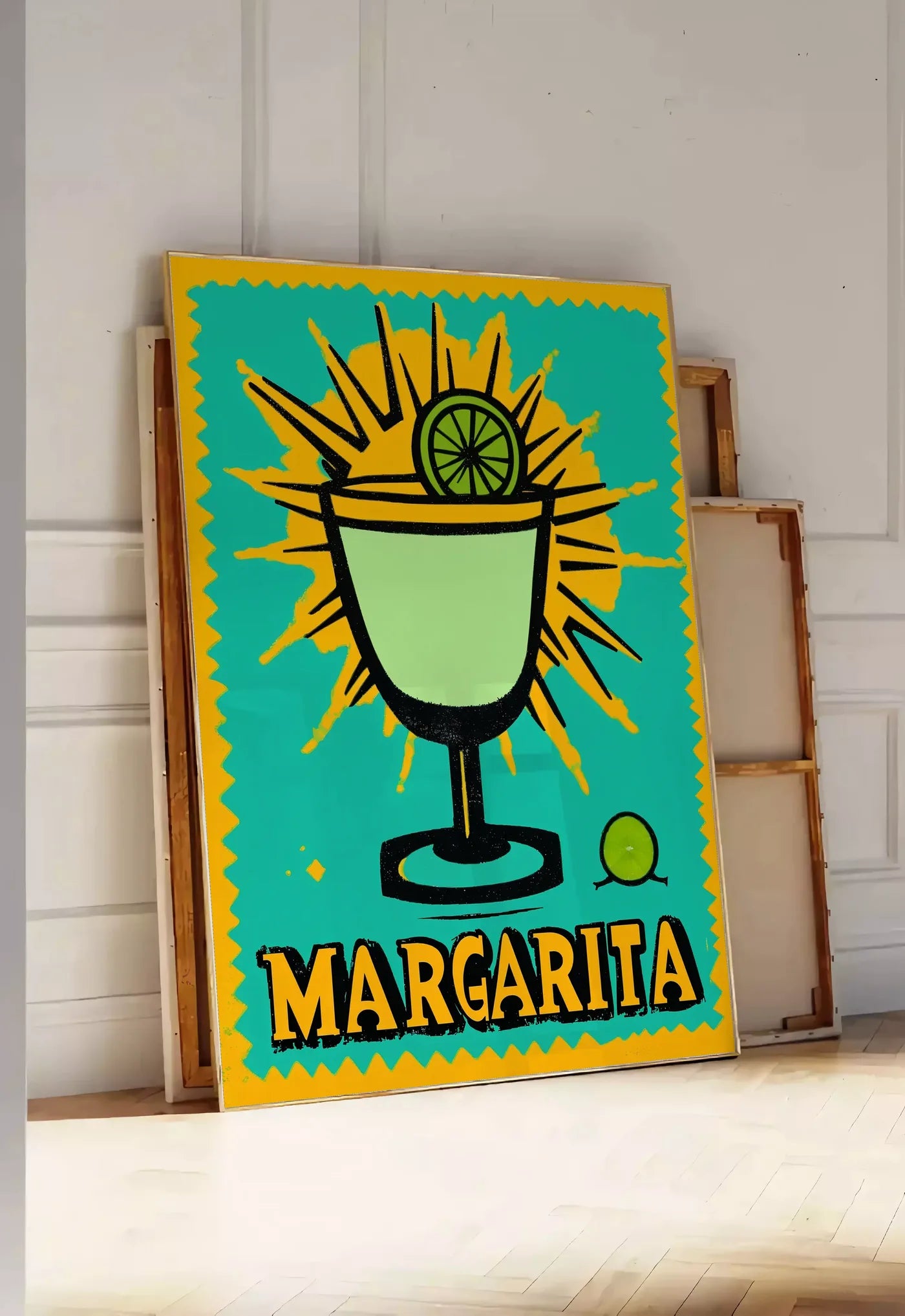 Tirage encadrable affiche cocktail Margarita pop art, posee au sol dans une entree lumineuse, contre un mur a panneaux blancs, a cote de chassis en bois empiles