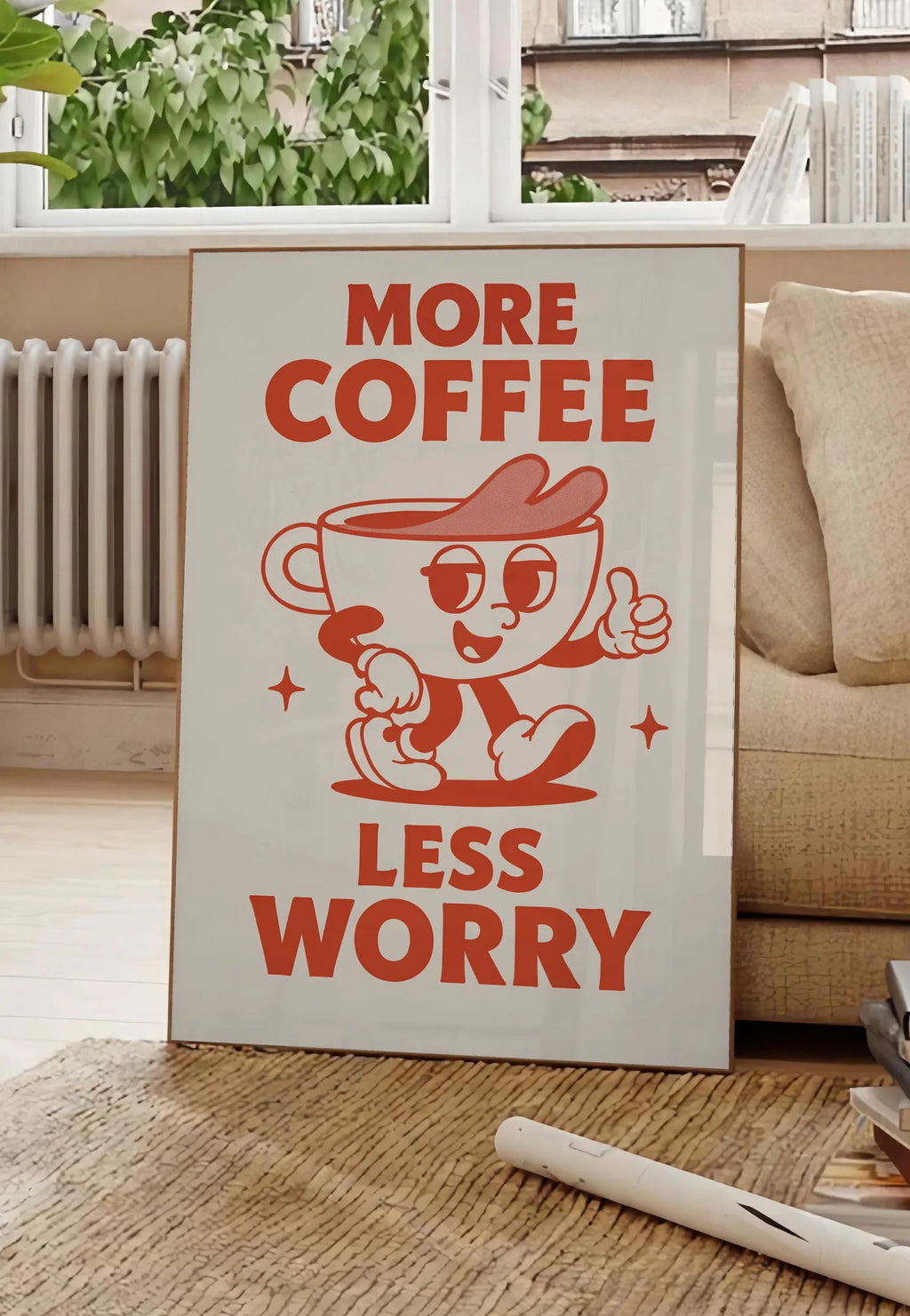 Poster affiche cuisine cafe More Coffee Less Worry, posee au sol dans un salon parisien, devant une grande fenetre donnant sur un immeuble haussmannien, entre un ficus et un canape creme