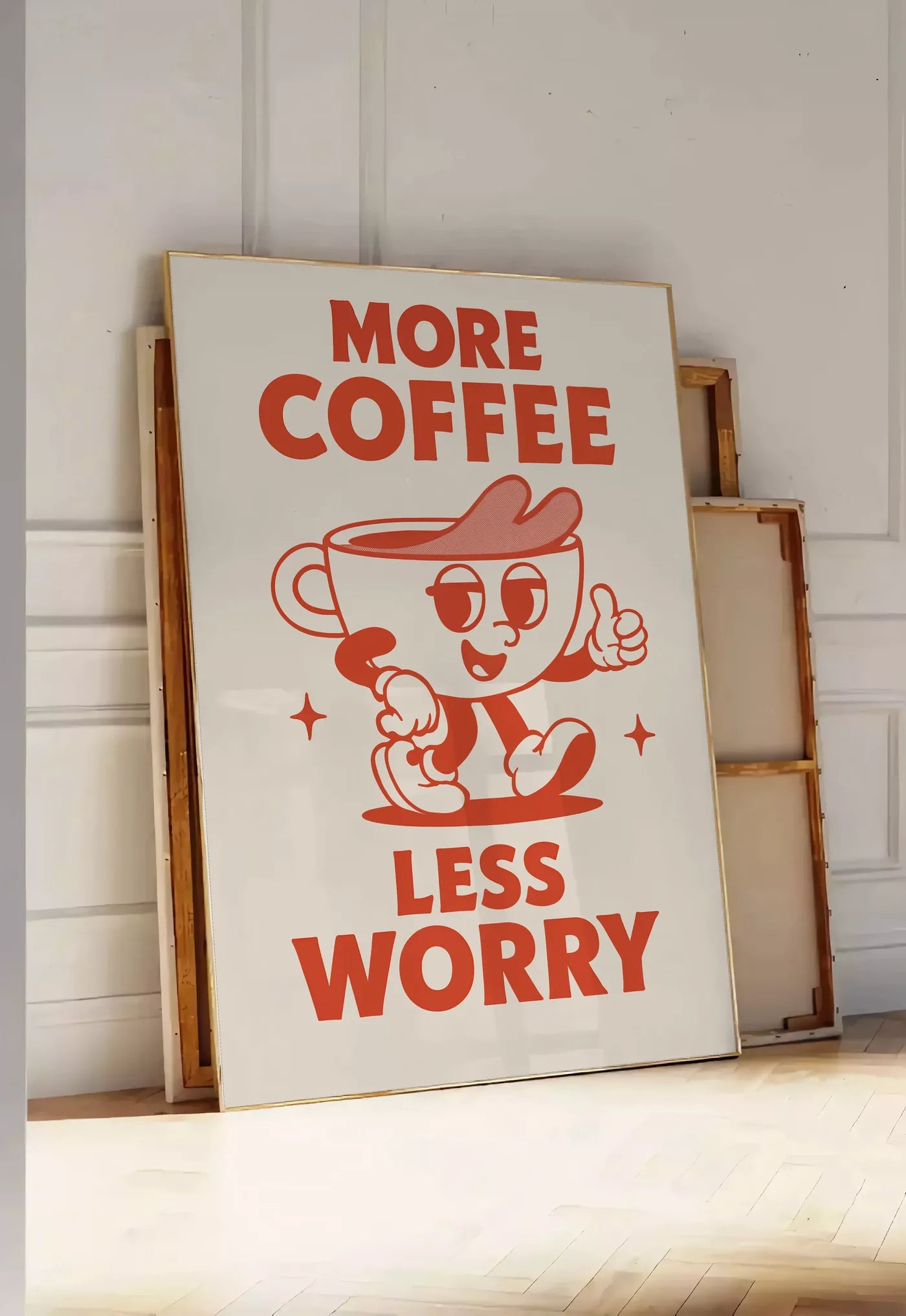 Tirage encadrable affiche cuisine cafe More Coffee Less Worry, posee au sol dans une entree lumineuse, contre un mur a panneaux blancs, a cote de chassis en bois empiles