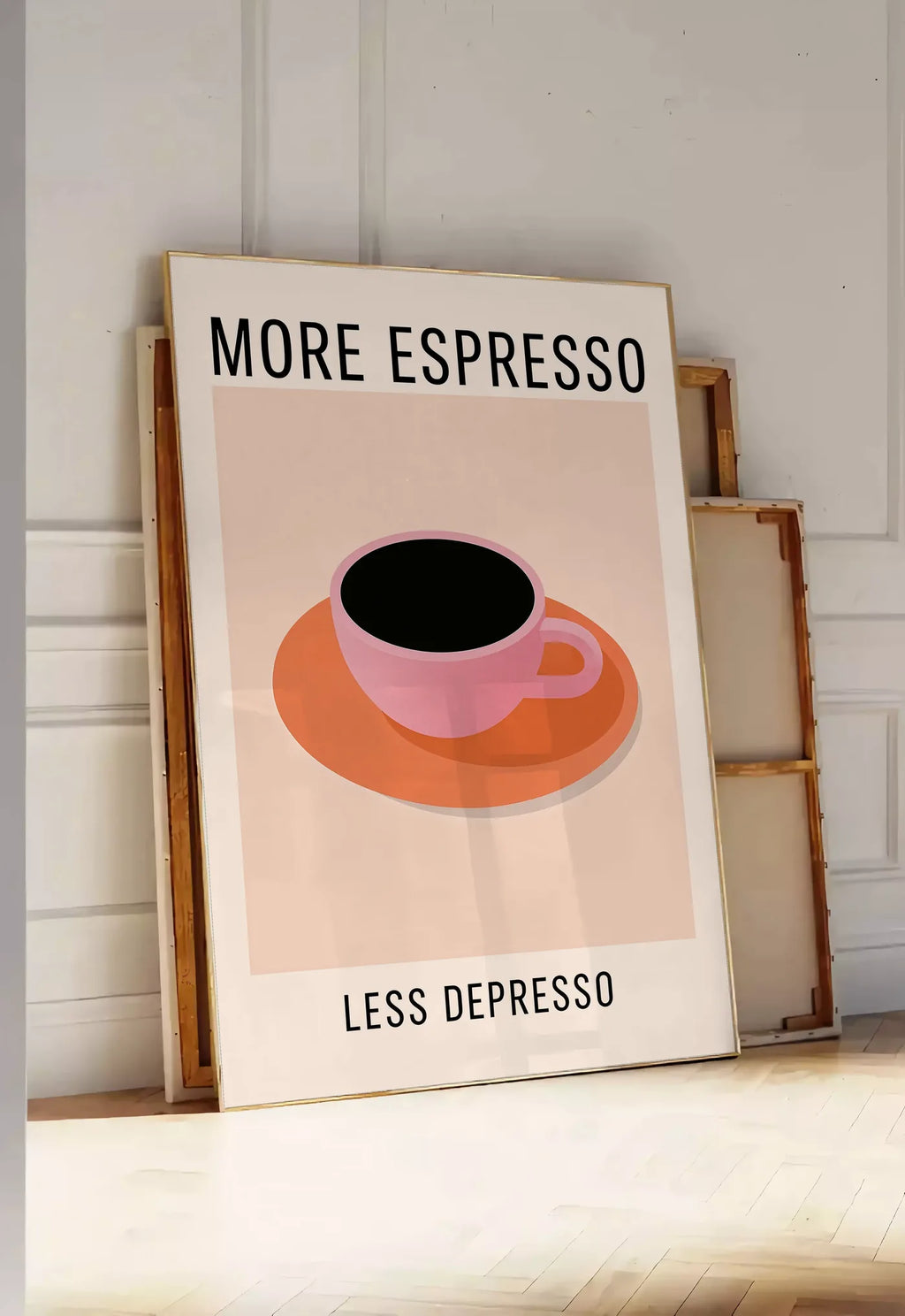 Tirage encadrable affiche cuisine cafe More Espresso, posee au sol dans une entree lumineuse, contre un mur a panneaux blancs, a cote de chassis en bois empiles