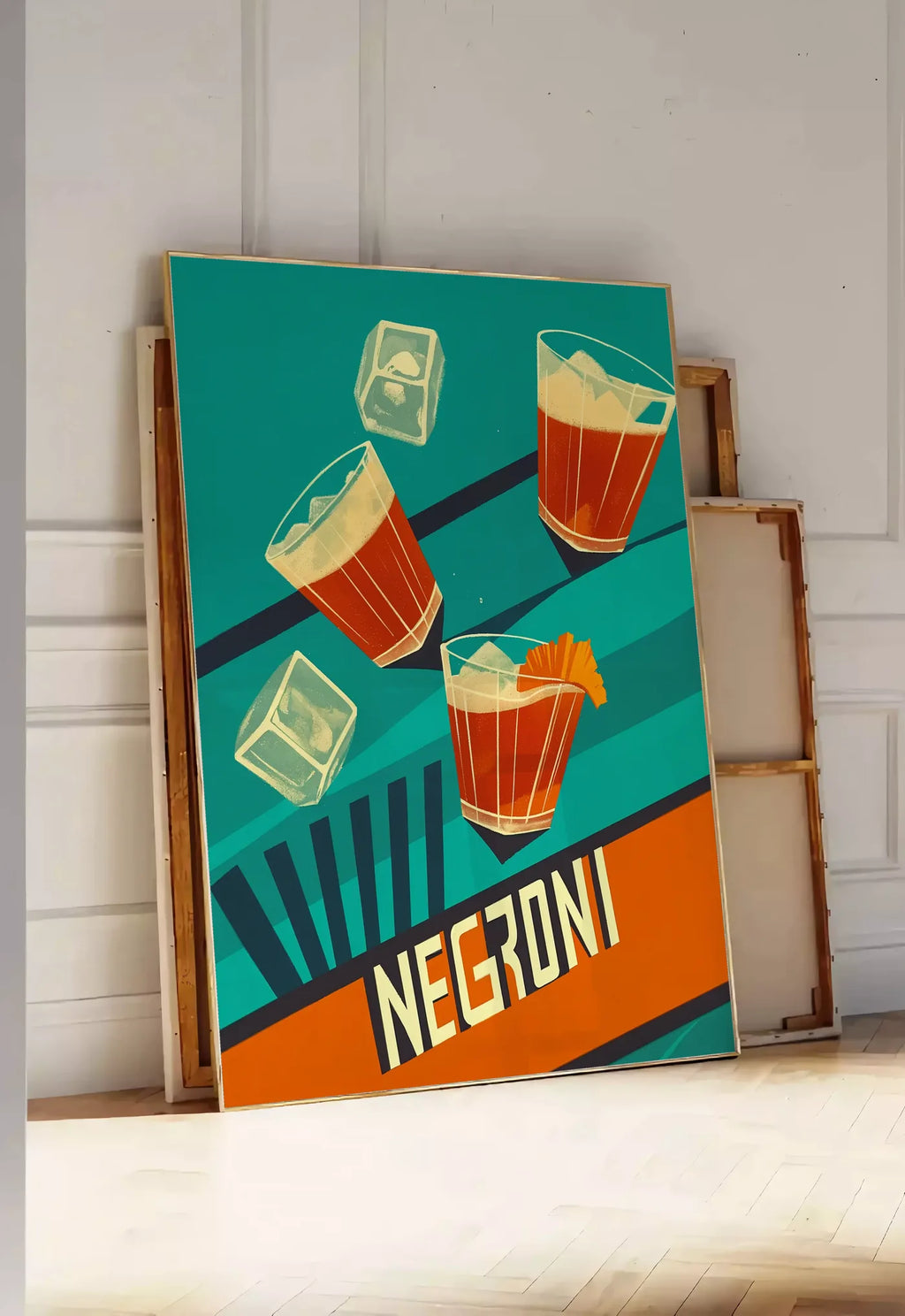 Tirage encadrable affiche cocktail Negroni, posee au sol dans une entree lumineuse, contre un mur a panneaux blancs, a cote de chassis en bois empiles