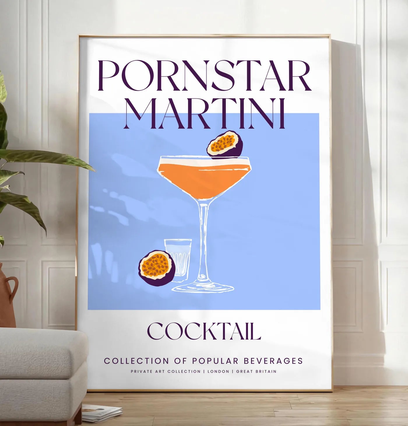 Reproduction affiche cocktail Pornstar Martini, posee au sol dans un salon minimaliste clair, a cote d'un canape beige et d'une plante verte, sur un parquet clair