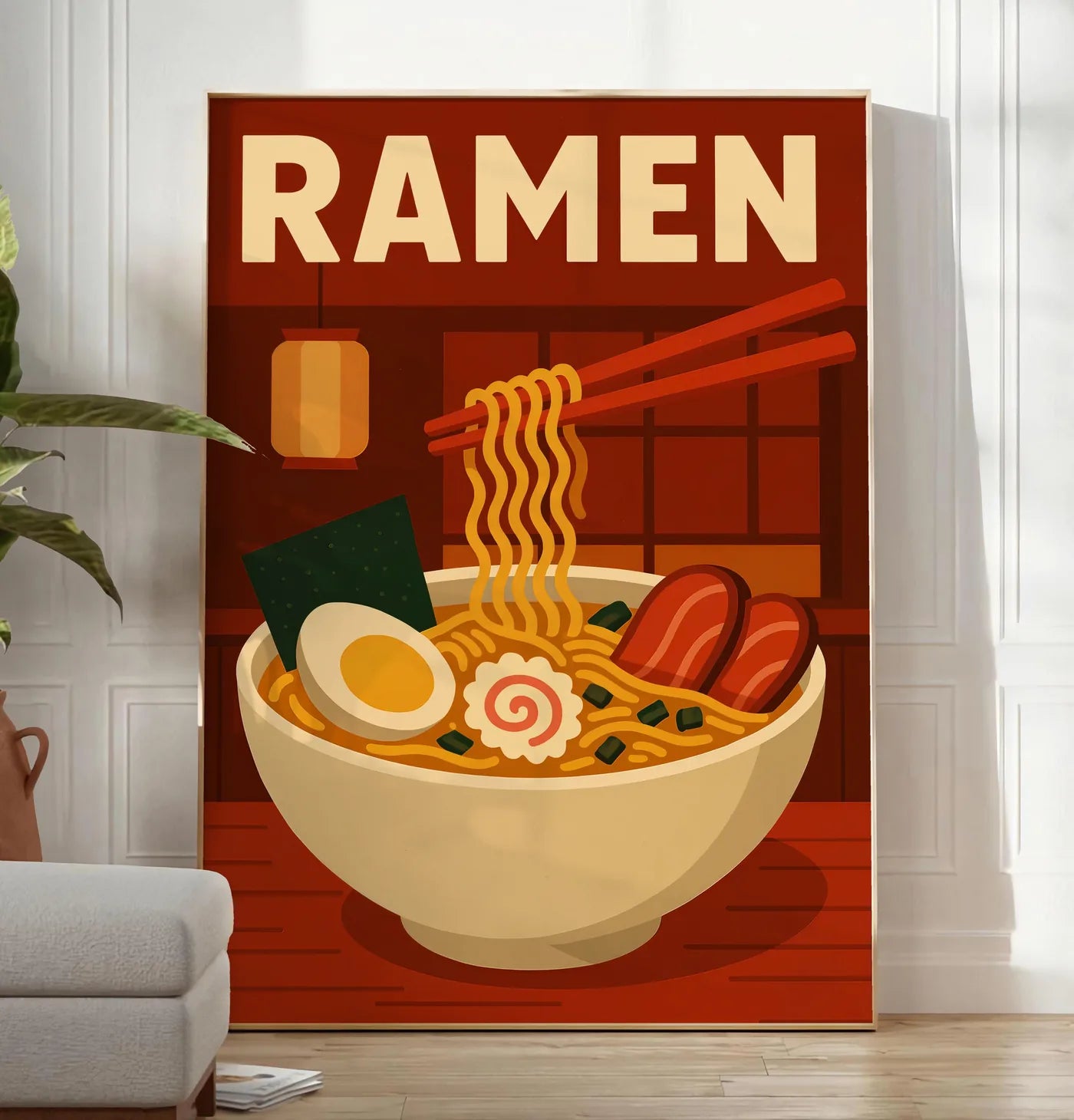 Reproduction affiche ramen bol et nouilles soulevees a la baguette dans une cuisine rouge brique, posee au sol dans un salon minimaliste clair, a cote d'un canape beige et d'une plante verte, sur un parquet clair