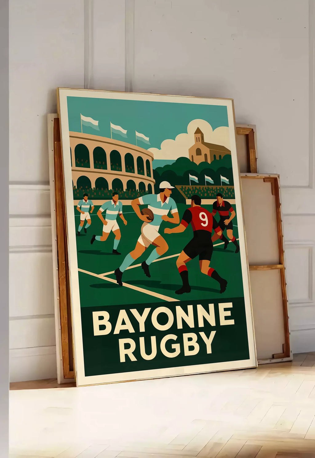 Tirage encadrable joueurs de rugby en maillots rayés, posee au sol dans une entree lumineuse, contre un mur a panneaux blancs, a cote de chassis en bois empiles