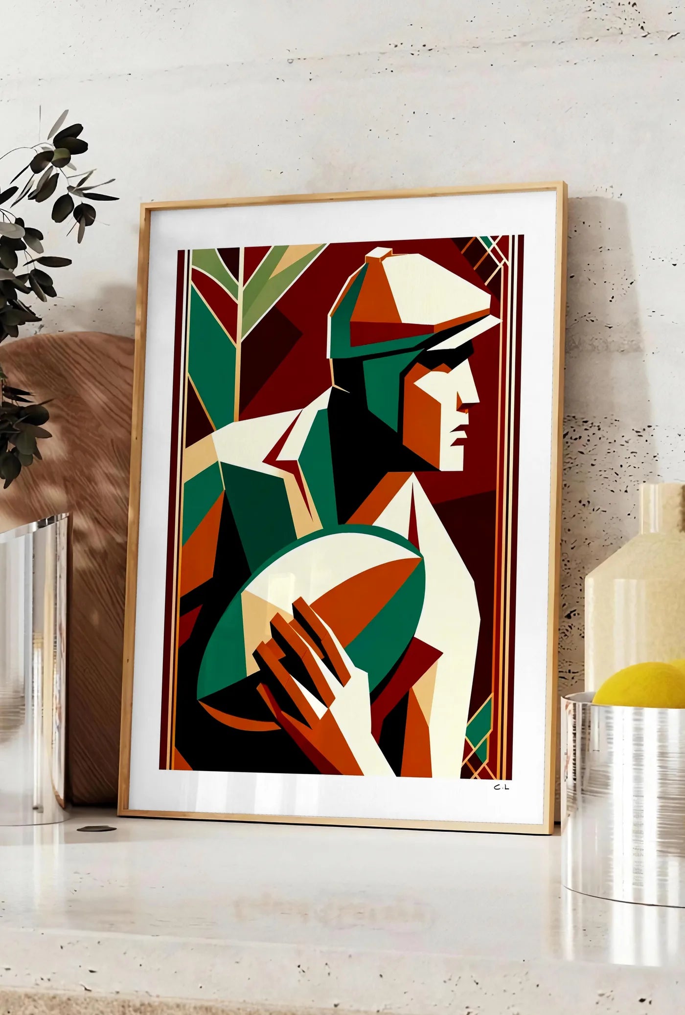 Affiche affiche rugby art deco, posee sur un plan de travail de cuisine en pierre claire, entre une branche d'eucalyptus en vase et un bocal de citrons