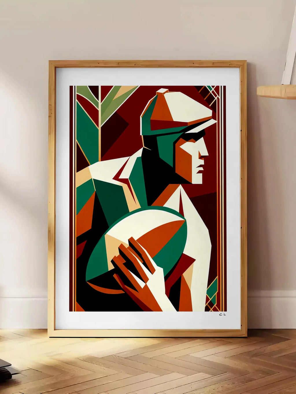 Estampe affiche rugby art deco, posee au sol dans un coin salon, sur un parquet a chevrons, pres d'une table d'appoint en chene chargee de livres