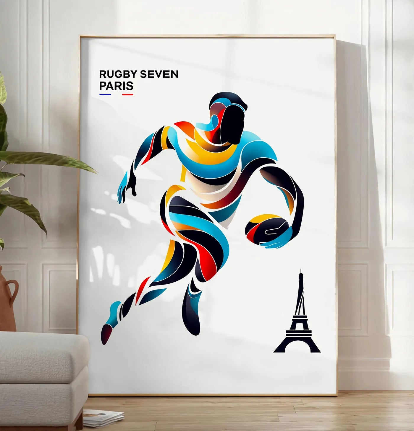 Reproduction affiche rugby Paris, posee au sol dans un salon minimaliste clair, a cote d'un canape beige et d'une plante verte, sur un parquet clair