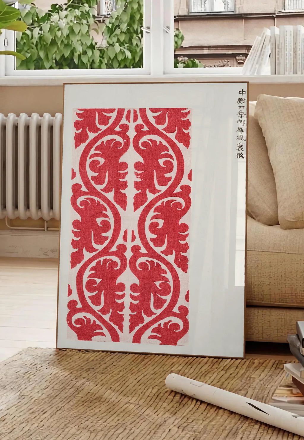 Poster affiche motif rouge de feuillage de Taguchi Tomoki, posee au sol dans un salon parisien, devant une grande fenetre donnant sur un immeuble haussmannien, entre un ficus et un canape creme