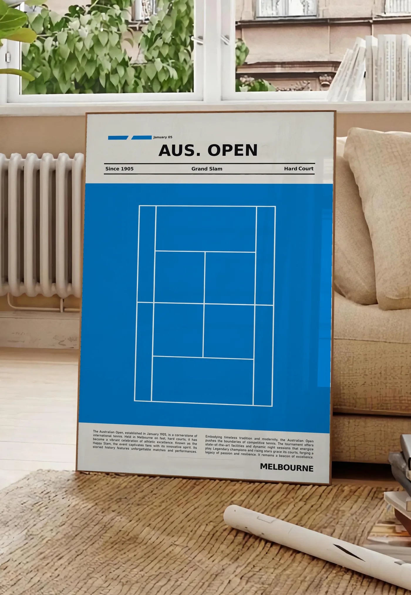 Poster court de tennis stylisé, posee au sol dans un salon parisien, devant une grande fenetre donnant sur un immeuble haussmannien, entre un ficus et un canape creme