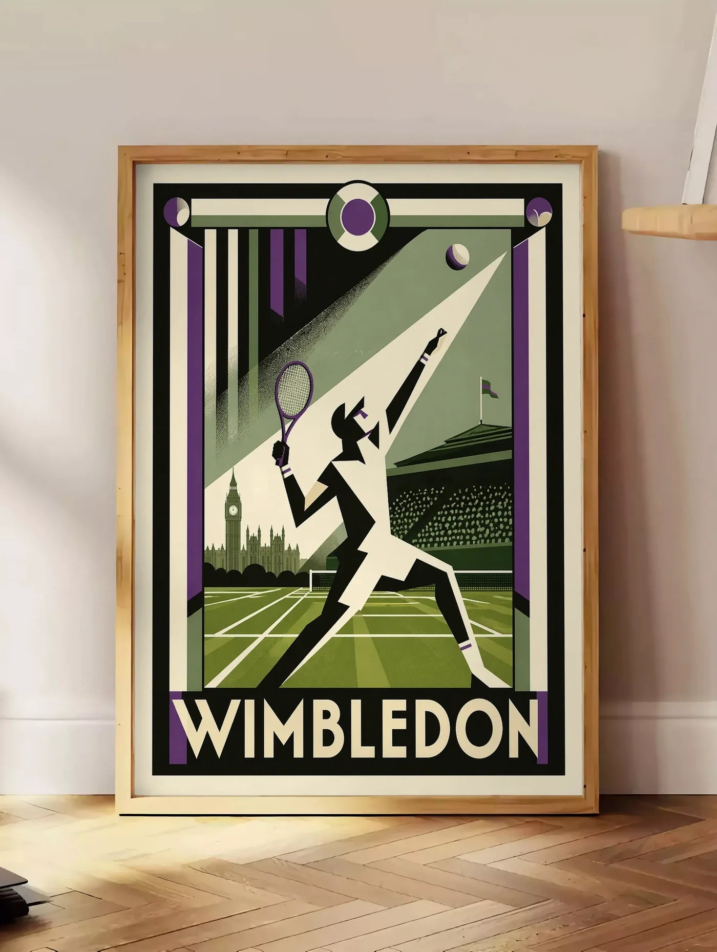 Estampe affiche Wimbledon Art Deco, posee au sol dans un coin salon, sur un parquet a chevrons, pres d'une table d'appoint en chene chargee de livres