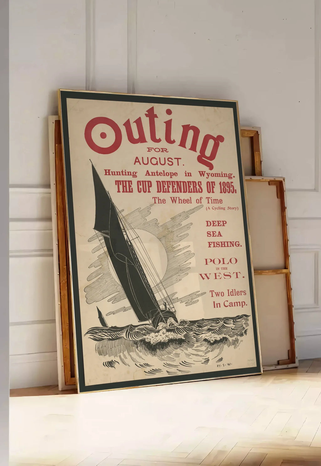 Tirage encadrable affiche Outing vintage, posee au sol dans une entree lumineuse, contre un mur a panneaux blancs, a cote de chassis en bois empiles
