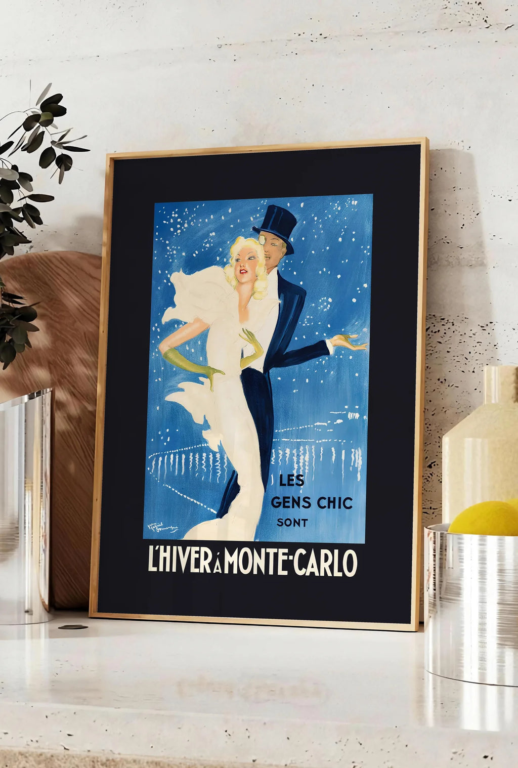 Affiche couple dansant élégant sous un ciel bleu de cobalt, posee sur un plan de travail de cuisine en pierre claire, entre une branche d'eucalyptus en vase et un bocal de citrons