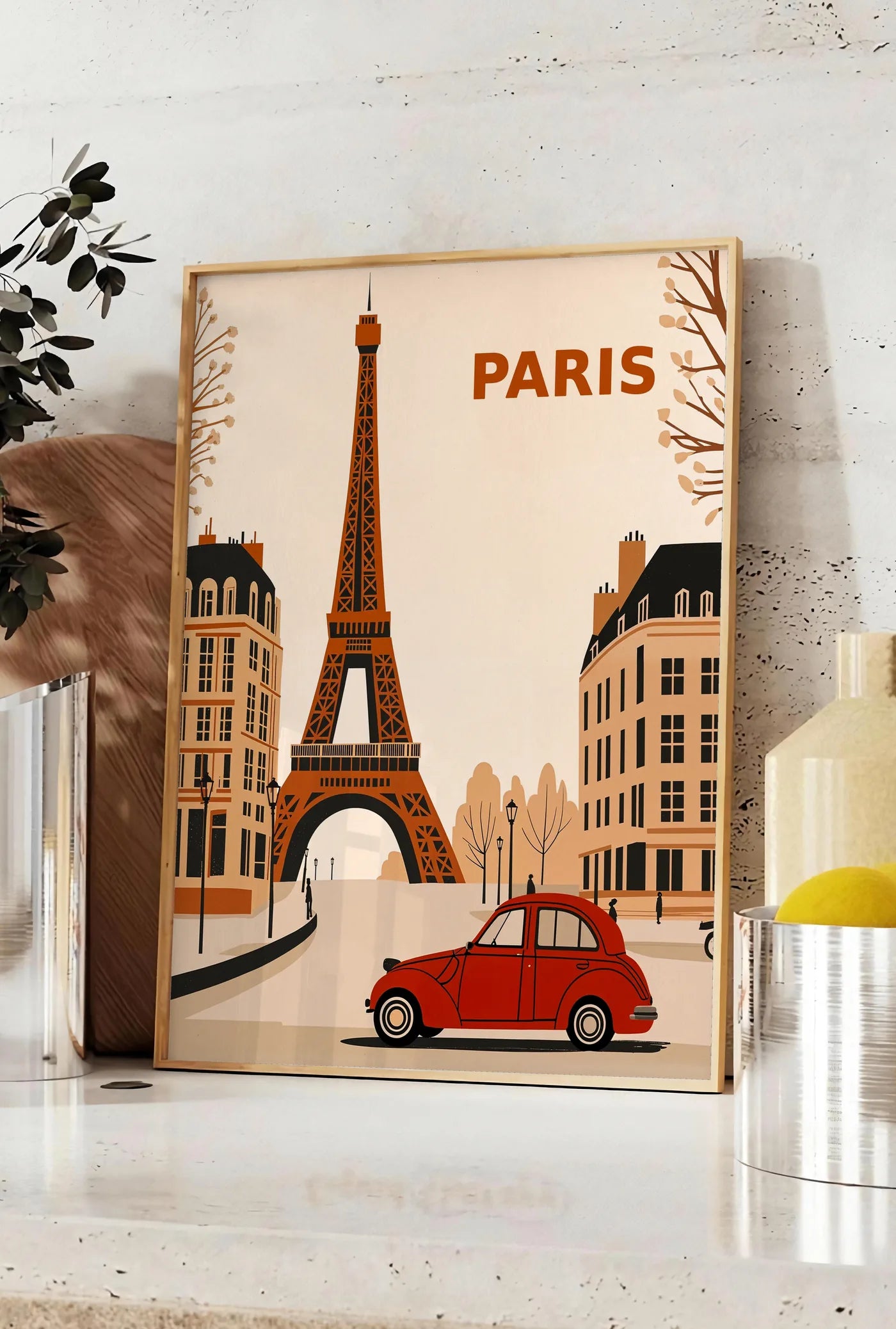 Affiche affiche Paris vintage, posee sur un plan de travail de cuisine en pierre claire, entre une branche d'eucalyptus en vase et un bocal de citrons