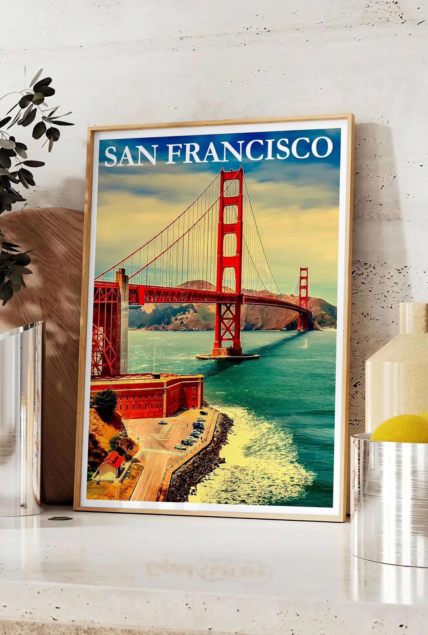 Affiche affiche San Francisco vintage, posee sur un plan de travail de cuisine en pierre claire, entre une branche d'eucalyptus en vase et un bocal de citrons