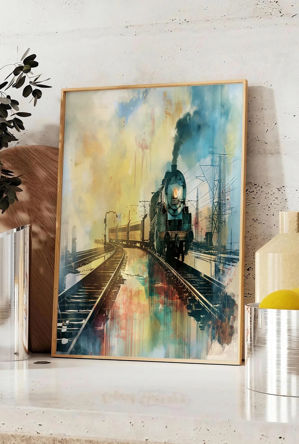 Affiche affiche train vapeur vintage, posee sur un plan de travail de cuisine en pierre claire, entre une branche d'eucalyptus en vase et un bocal de citrons