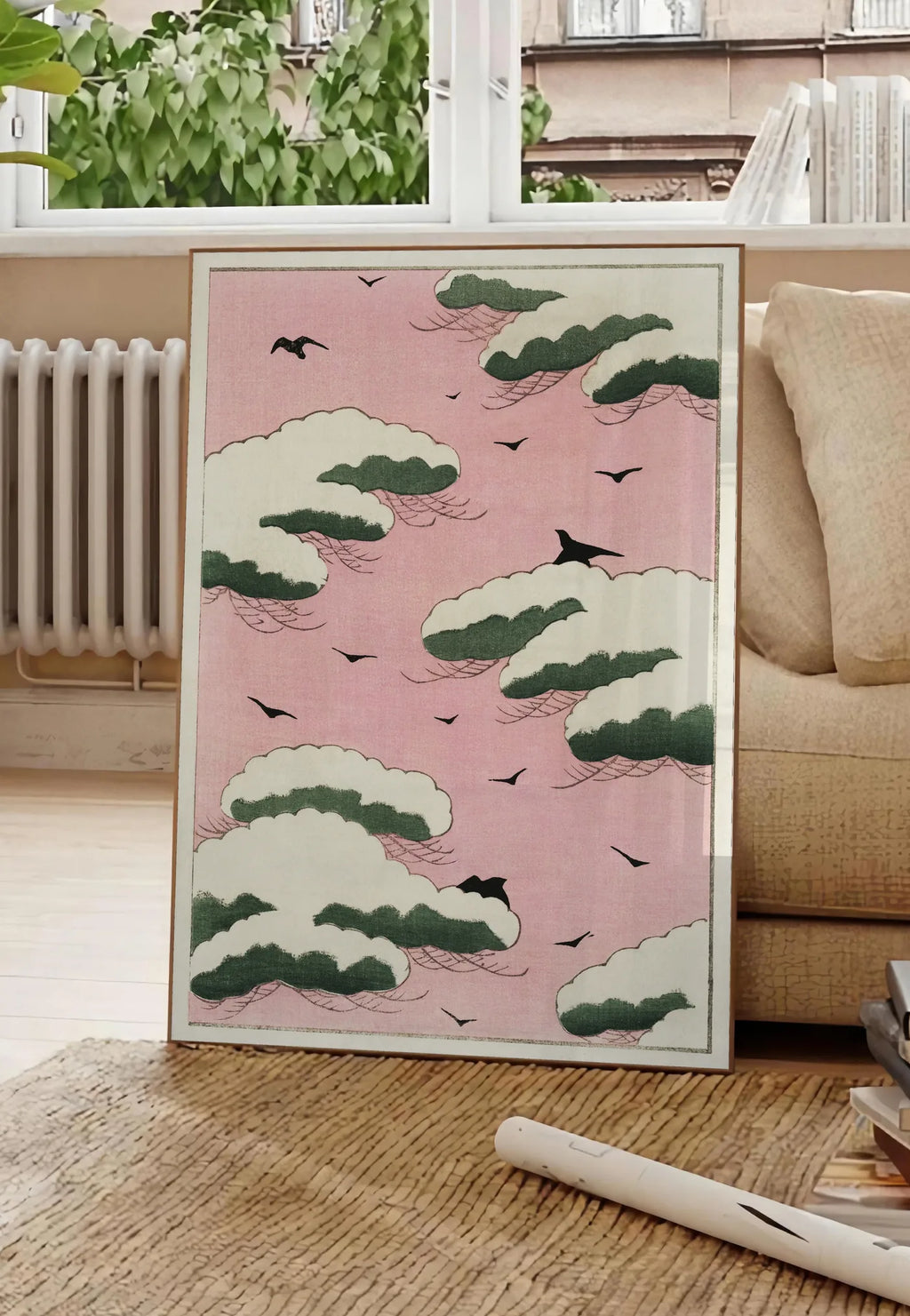 Poster affiche nuages verts et oiseaux sur ciel rose de Watanabe Seitei estampe japonaise, posee au sol dans un salon parisien, devant une grande fenetre donnant sur un immeuble haussmannien, entre un ficus et un canape creme